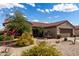 Single-Gathering home showcasing mature desert landscaping and a neutral color scheme at 15691 W Arbor Trl, Surprise, AZ 85374