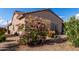 Charming home exterior with a beautiful flowering shrub adding curb appeal at 15691 W Arbor Trl, Surprise, AZ 85374