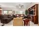 Bright living room with large windows, comfortable seating, and built-in entertainment center at 15691 W Arbor Trl, Surprise, AZ 85374
