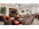 Cozy living room featuring a large entertainment center, comfortable seating, and neutral tones at 15691 W Arbor Trl, Surprise, AZ 85374