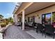 Expansive covered patio with multiple seating areas, ideal for relaxing and entertaining guests at 15691 W Arbor Trl, Surprise, AZ 85374