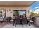 Covered patio area perfect for outdoor dining with a table, chairs, and pleasant view at 15691 W Arbor Trl, Surprise, AZ 85374