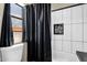 Bright bathroom with a white tile shower-tub combo with modern tile accent and dark shower curtain at 15834 E Sunflower Dr # 2, Fountain Hills, AZ 85268