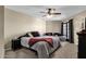 Comfortable bedroom featuring plush carpet, ceiling fan and a sliding glass door to an outdoor patio at 15834 E Sunflower Dr # 2, Fountain Hills, AZ 85268