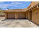 Spacious two-car garage with desert-toned stucco and tile roof with desert landscaping surrounding at 15834 E Sunflower Dr # 2, Fountain Hills, AZ 85268