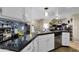 Open kitchen with dark countertops, stainless steel dishwasher, and white cabinetry at 15834 E Sunflower Dr # 2, Fountain Hills, AZ 85268
