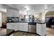 Open kitchen with black countertops, white cabinetry, mosaic backsplash, and stainless steel dishwasher at 15834 E Sunflower Dr # 2, Fountain Hills, AZ 85268
