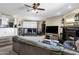 Open concept living room with a cozy fireplace, neutral colors, and a partial view of the kitchen at 15834 E Sunflower Dr # 2, Fountain Hills, AZ 85268