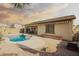 Inviting backyard featuring a refreshing pool, patio area, and desert landscaping at 16448 W Tether Trl, Surprise, AZ 85387