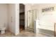 Bathroom with a glass-enclosed shower, soaking tub, tile floors, and neutral-colored walls at 16448 W Tether Trl, Surprise, AZ 85387