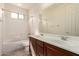 Bright bathroom with double sinks, tile floors, and a shower-tub combination at 16448 W Tether Trl, Surprise, AZ 85387