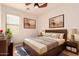 Comfortable bedroom with stylish decor, a ceiling fan, and natural light from a window at 16448 W Tether Trl, Surprise, AZ 85387