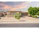 Beautiful single-Gathering home with desert landscaping, a three-car garage, and blue sky at sunset at 16448 W Tether Trl, Surprise, AZ 85387