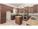 Well-lit kitchen featuring granite countertops, stainless steel appliances, and custom wood cabinetry and a center island at 16448 W Tether Trl, Surprise, AZ 85387