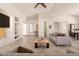 Bright living room with a high ceiling, tile floors, neutral colors, and an open floor plan at 16448 W Tether Trl, Surprise, AZ 85387