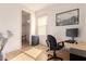 Bright office featuring wood floors, neutral walls, a desk, and a chair, perfect for remote work at 16448 W Tether Trl, Surprise, AZ 85387