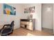Office featuring neutral colored walls, wood floors, and custom shelving for storage and decor at 16448 W Tether Trl, Surprise, AZ 85387