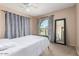 Bright bedroom featuring a large window, carpet, and neutral paint at 16814 N 31St Ave, Phoenix, AZ 85053