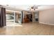 Open bonus room with patio access, tile flooring, a ceiling fan, and bar seating at 16814 N 31St Ave, Phoenix, AZ 85053