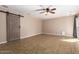Versatile bonus room with ceramic tile flooring, barn door access, and natural lighting at 16814 N 31St Ave, Phoenix, AZ 85053