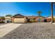 Charming single-story home with desert landscaping, arched window, and an attached two-car garage at 16814 N 31St Ave, Phoenix, AZ 85053
