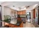 Inviting kitchen featuring granite countertops, tile backsplash, stainless steel appliances, and adjacent dining area at 16814 N 31St Ave, Phoenix, AZ 85053