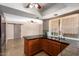 Open kitchen featuring a breakfast bar, stainless steel appliances, natural light, and easy access to the living area at 16814 N 31St Ave, Phoenix, AZ 85053