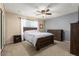 Calm bedroom with a large bed, dresser, carpet, and access to natural light from the sliding glass door at 16814 N 31St Ave, Phoenix, AZ 85053