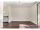 An empty bedroom featuring hardwood floors, neutral walls, and a door leading to a bathroom with vanity at 1825 W Ray Rd # 2111, Chandler, AZ 85224