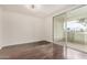 Bright bedroom with hardwood floors, an overhead light fixture, and large sliding doors to a balcony at 1825 W Ray Rd # 2111, Chandler, AZ 85224