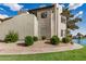Condo exterior featuring manicured landscaping, modern architecture, and tranquil waterfront views in a serene setting at 1825 W Ray Rd # 2111, Chandler, AZ 85224