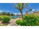 Exterior view of lakeside sidewalk, trees, lake, and bench at 1825 W Ray Rd # 2111, Chandler, AZ 85224