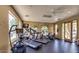Well-lit fitness center with treadmills, elliptical machines, and large windows at 1825 W Ray Rd # 2111, Chandler, AZ 85224