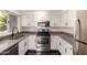 Bright kitchen with stainless steel appliances, granite countertops, and white cabinets at 1825 W Ray Rd # 2111, Chandler, AZ 85224