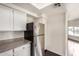 Bright kitchen with stainless appliances, granite countertops, white cabinets, and dark wood flooring at 1825 W Ray Rd # 2111, Chandler, AZ 85224