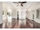 Spacious living room with hardwood floors, a ceiling fan, and plentiful natural light streaming through multiple windows at 1825 W Ray Rd # 2111, Chandler, AZ 85224
