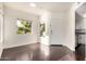 Bright living room featuring wood floors, large windows offering natural light, and a white front door at 1825 W Ray Rd # 2111, Chandler, AZ 85224