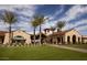 Upscale community clubhouse featuring a manicured lawn, tile roof, and covered entryway with shade at 18702 N 267Th Dr, Buckeye, AZ 85396