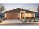 Charming single-story home with a tile roof, desert landscaping, and a spacious two-car garage at 18702 N 267Th Dr, Buckeye, AZ 85396