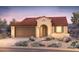 Charming single-story home featuring a tile roof, arched entryway, and a well-maintained desert landscape at 18716 N 268Th Ave, Buckeye, AZ 85396