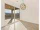 Modern dining area with decorative lighting fixture and sliding glass door to backyard at 20279 N 224Th Dr, Surprise, AZ 85387