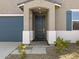 Close-up of a modern front door with a covered entryway and neutral-colored exterior at 20279 N 224Th Dr, Surprise, AZ 85387