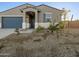 Inviting single story home with desert landscape, covered entry, and a two-car garage at 20279 N 224Th Dr, Surprise, AZ 85387