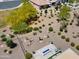 An aerial view shows a desert landscaped backyard with a built in fire-pit and seating area at 21090 N 267Th Dr, Buckeye, AZ 85396