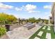 Inviting backyard with blue fire pit, artificial turf, and desert landscaping at 21090 N 267Th Dr, Buckeye, AZ 85396