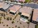 Aerial view of an outdoor patio with a seating area, artificial grass, and desert landscaping at 21090 N 267Th Dr, Buckeye, AZ 85396