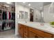 Elegant bathroom with double sinks, spacious countertops, and an open view to the closet at 21090 N 267Th Dr, Buckeye, AZ 85396