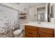 Cozy bathroom with wood vanity, floral shower curtain, and cute decor at 21090 N 267Th Dr, Buckeye, AZ 85396