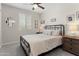 Comfortable bedroom with a ceiling fan and a decorative mirror above the bed at 21090 N 267Th Dr, Buckeye, AZ 85396