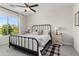 Cozy bedroom with neutral tones, a large window, and a comfortable bed at 21090 N 267Th Dr, Buckeye, AZ 85396